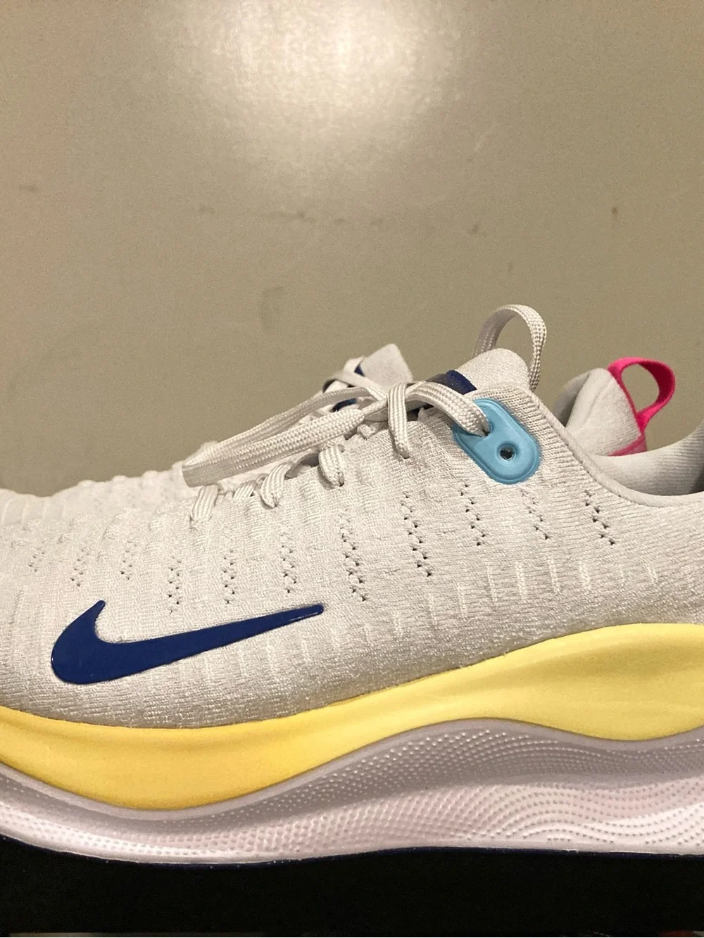 Nike White Athletic Shoes with Blue Swoosh and Yellow Midsole